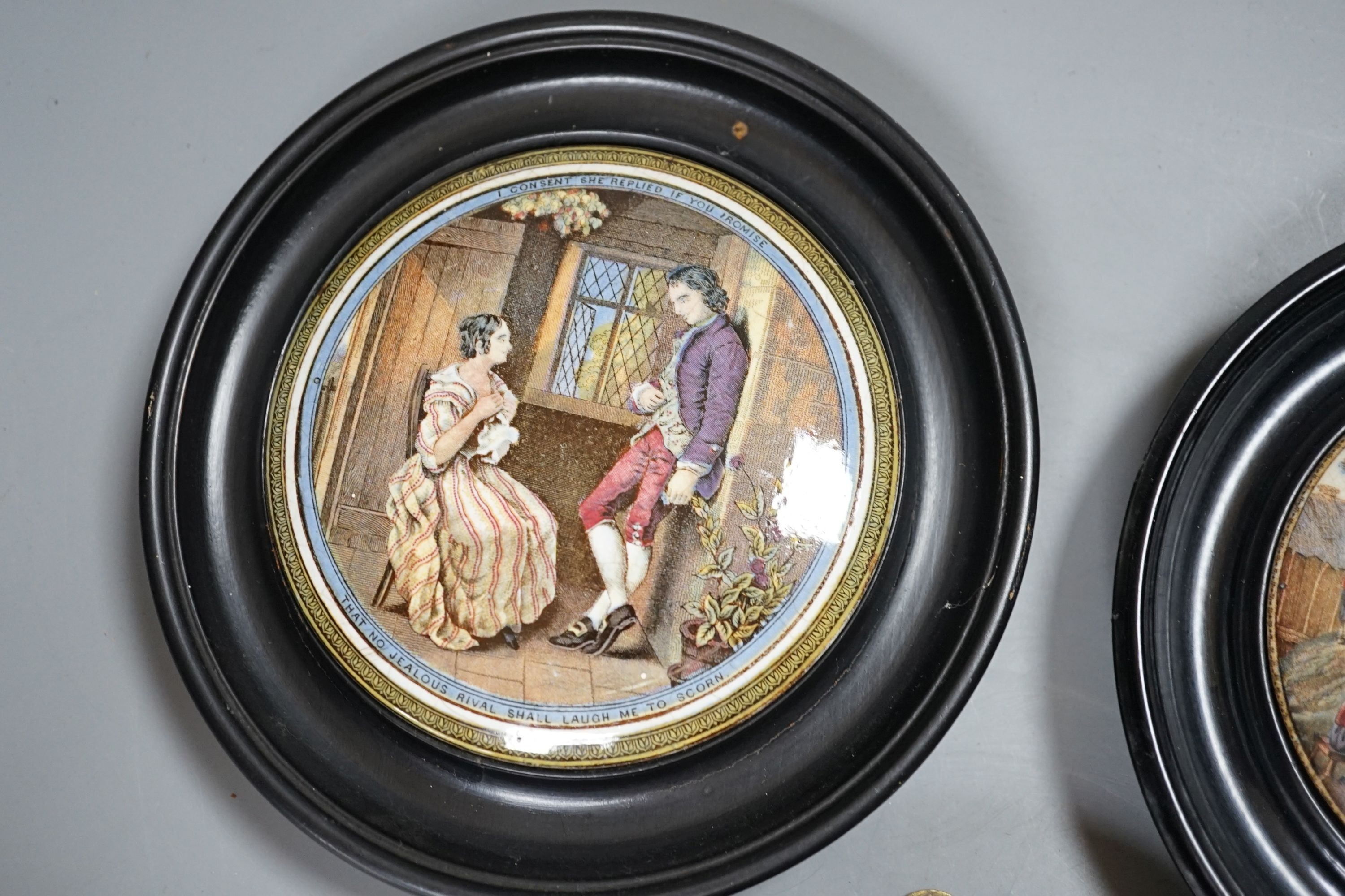 Seven Prattware pot lids, mounted in ebonised wood frames, an F & R Pratt plate and two pot lids with bases